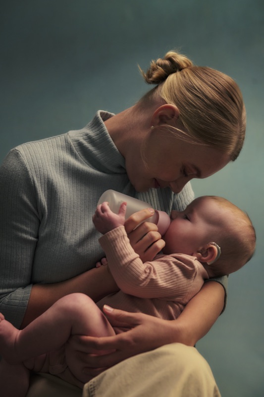 A mother holding her baby close
