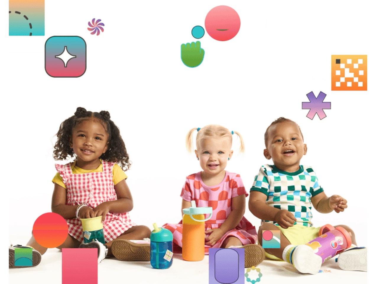 Three toddlers sitting together surrounded by colorful shapes