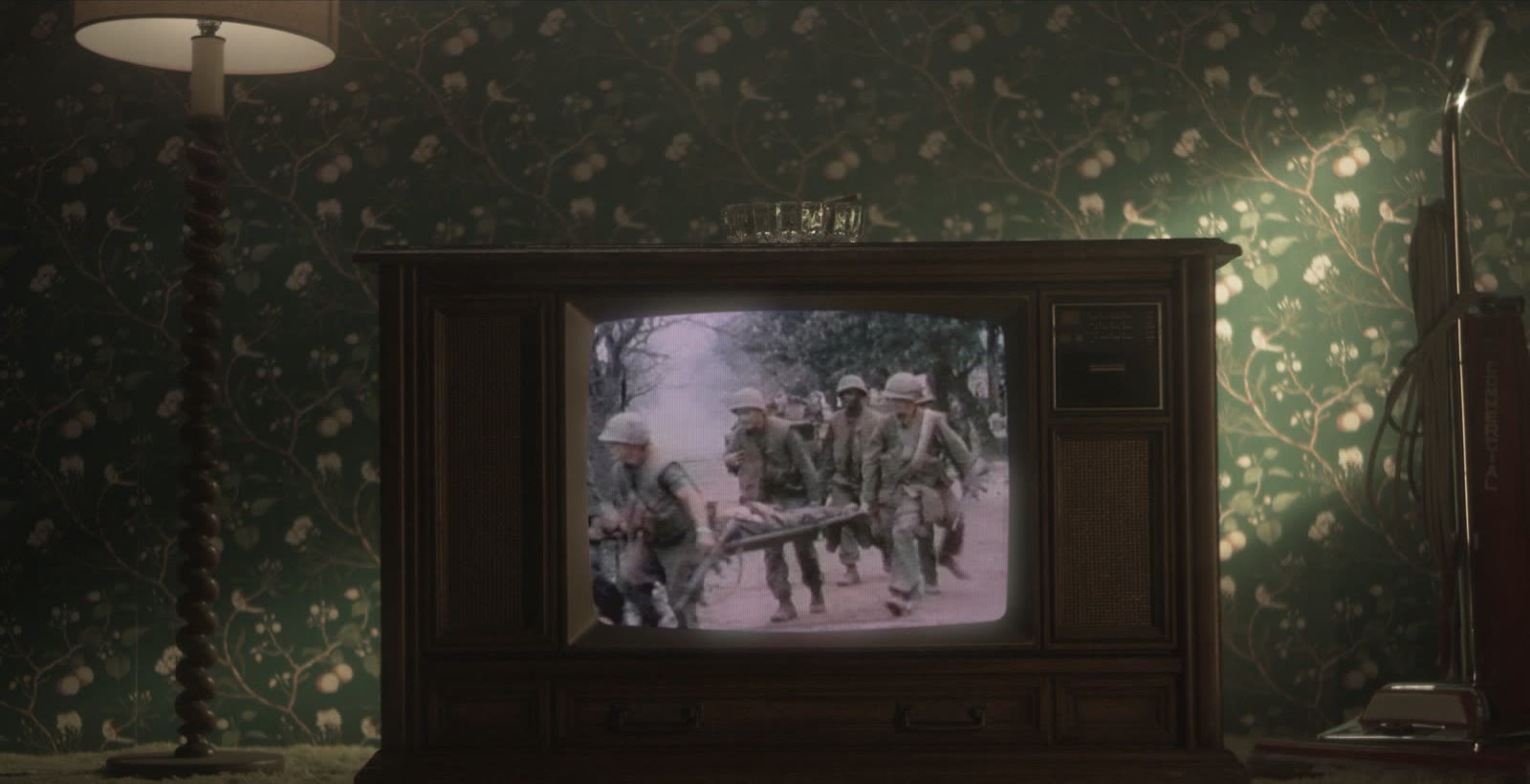 A vintage television showing soldiers carrying a stretcher