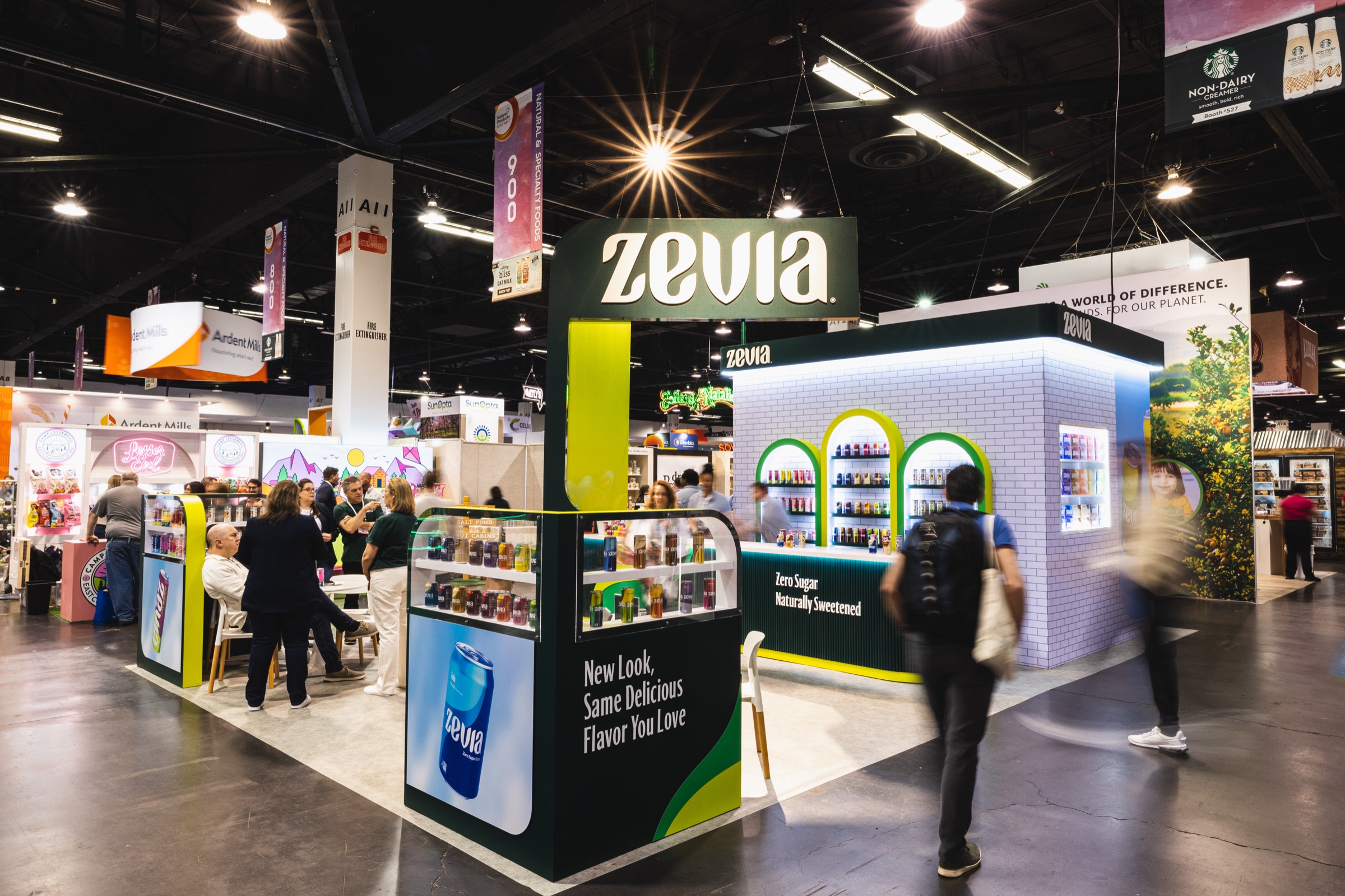 The Zevia booth at Expo West, with visitors walking past